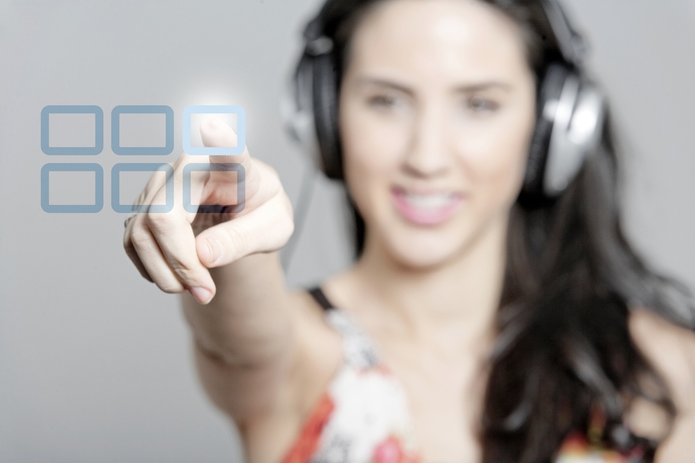 Woman selecting a song to listen to by pressing a concept button.jpeg