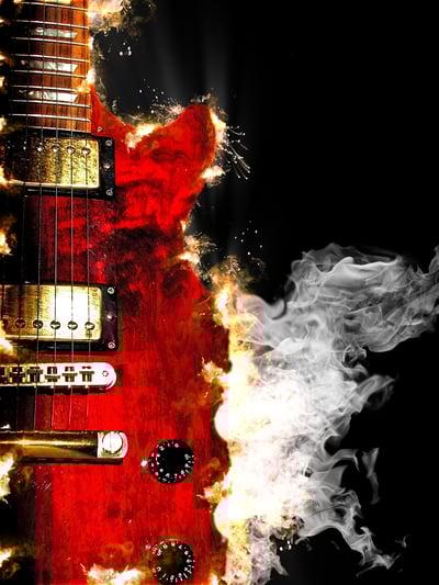 music concept with burn in fire and smoke design red electric guitar isolated on black background in dark.jpeg